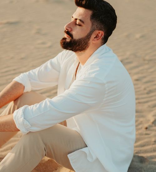 Serene person sitting in a relaxed meditative pose.
